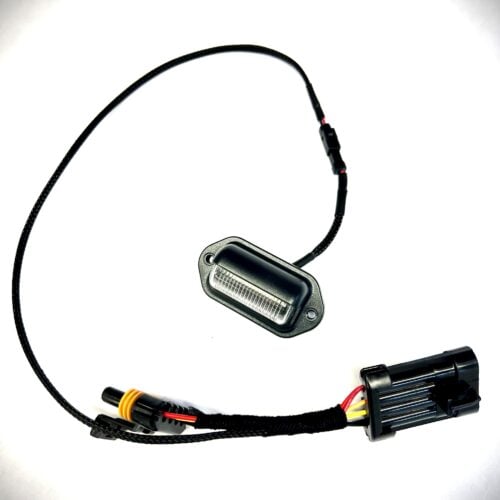 Black LED license plate light with wiring harness connector.